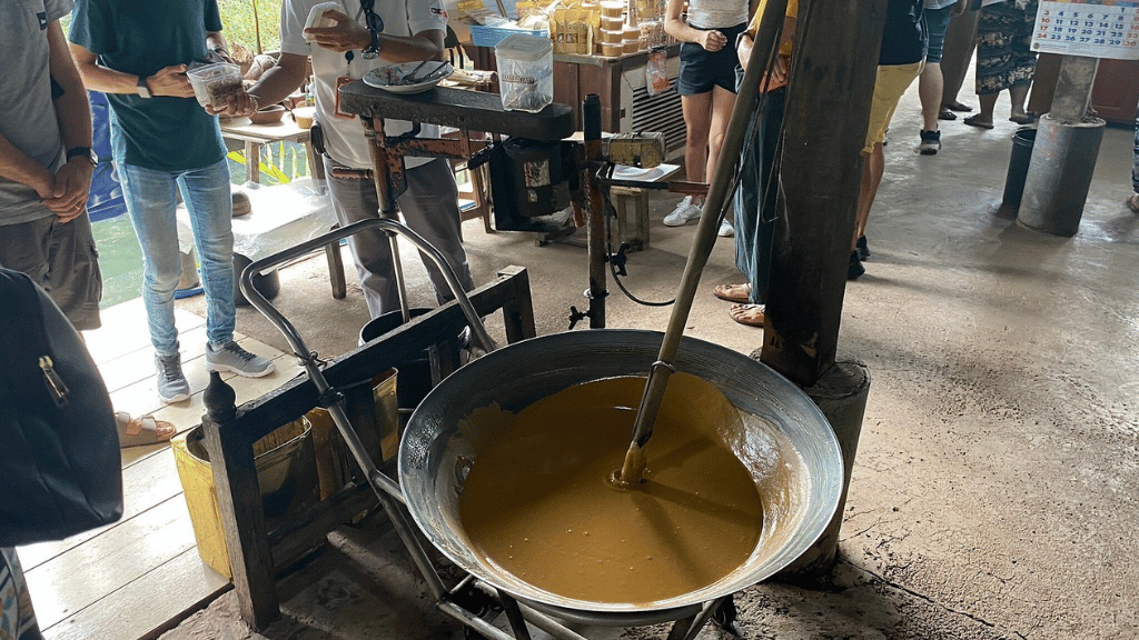 Traditional palm sugar production at the floating market