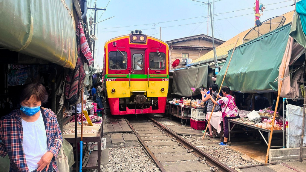 The moment the train crosses Mae Khlong Market