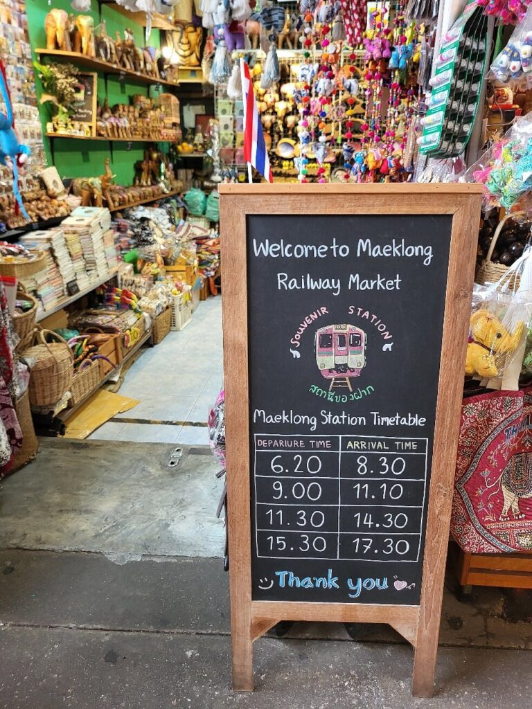 Train timetable at Mae Khlong Railway Market