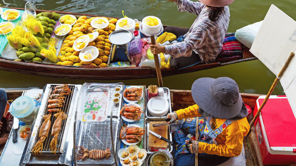 Enjoying Thai food on a boat at Damnoen Saduak Floating Market