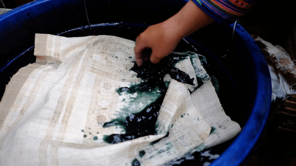 Fabric immersed in indigo dye after beeswax drawing