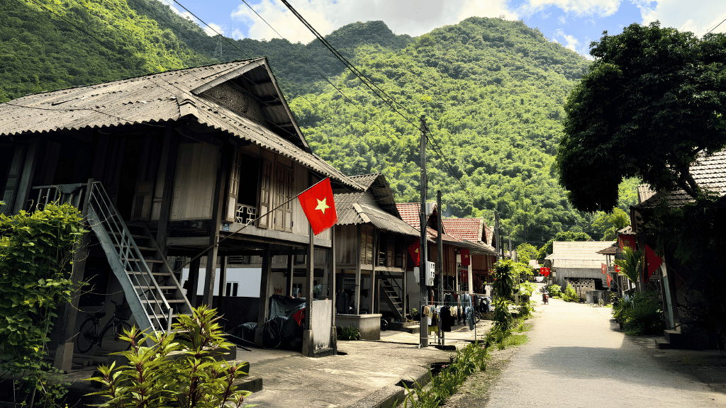 Daily life flows peacefully around traditional stilt houses in Van Village