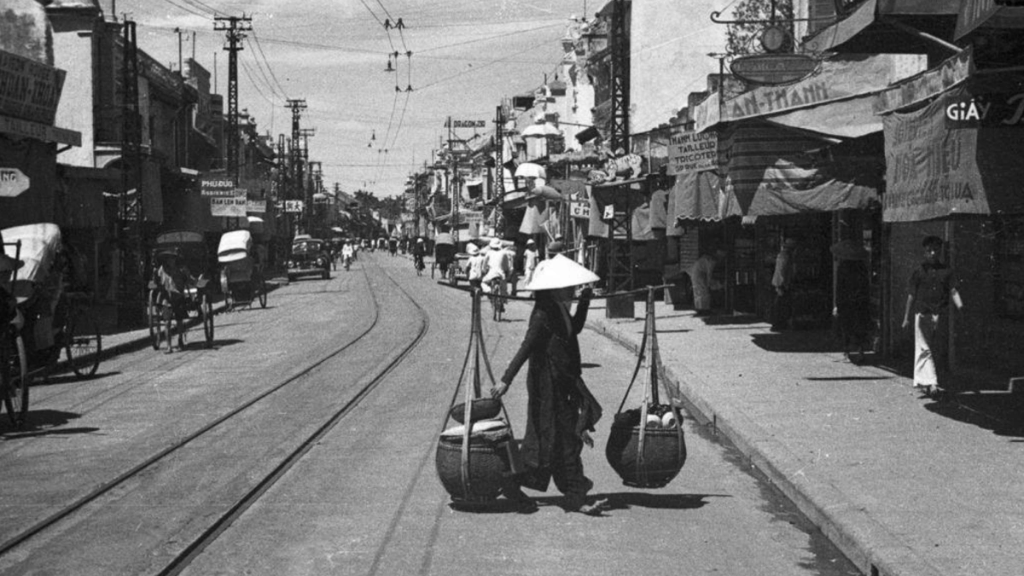 Daily life in Hanoi with a street vendor on Hang Dao Street, 1941, photo by Harrison Forman