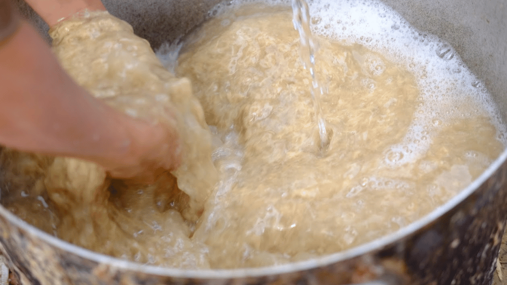 Once the giang has softened, it is pounded and filtered to remove coarse fibers. The resulting pulp is then mixed with water and stirred until smooth and even, revealing fine fibers ready to form the paper