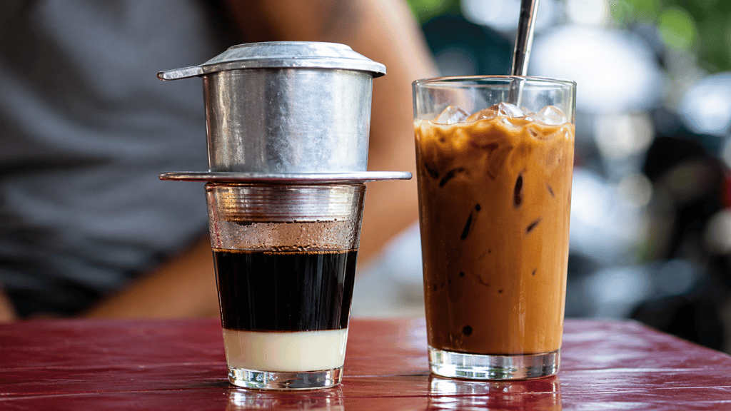 A glass of Vietnamese iced milk coffee served over ice